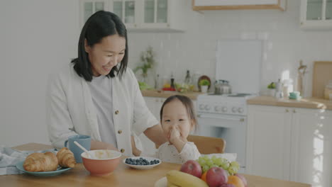 Mother and Daughter Enjoying Breakfast