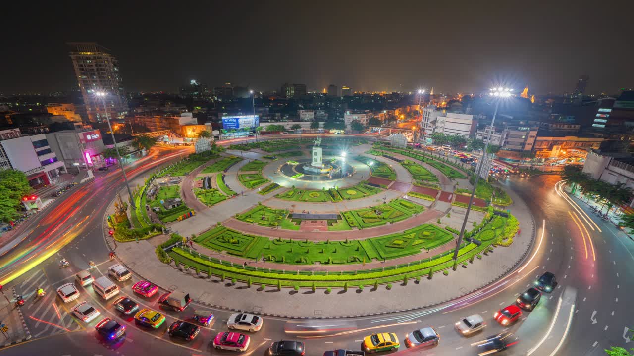 Time lapse of Wongwian Yai roundabout. Aerial view of highway junctions. Roads shape circle in structure of architecture and technology transportation concept. Urban city, Bangkok at night, Thailand.