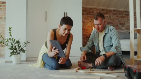 couple assembling furniture at home