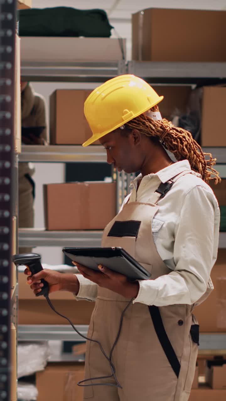 Vertical video: African american woman scanning barcodes on boxes