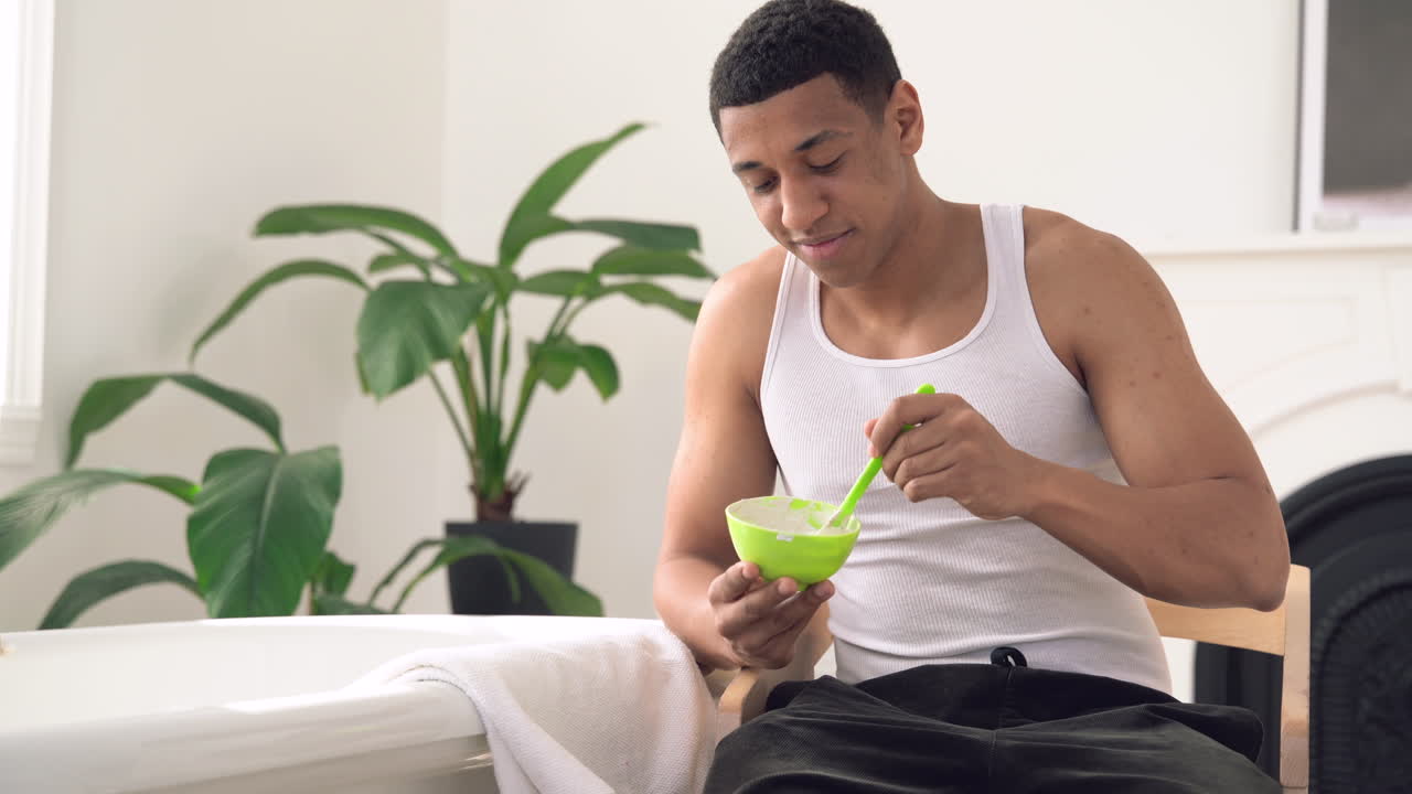 Handsome Black Male Preparing Facial Mask