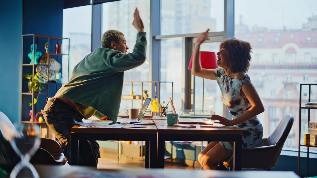 Coworkers celebrating success office, man woman throwing papers, teamwork joy