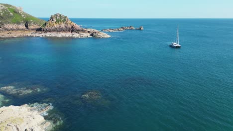 small catamaran moored in portelet beach jersey channel islands drone,aerial