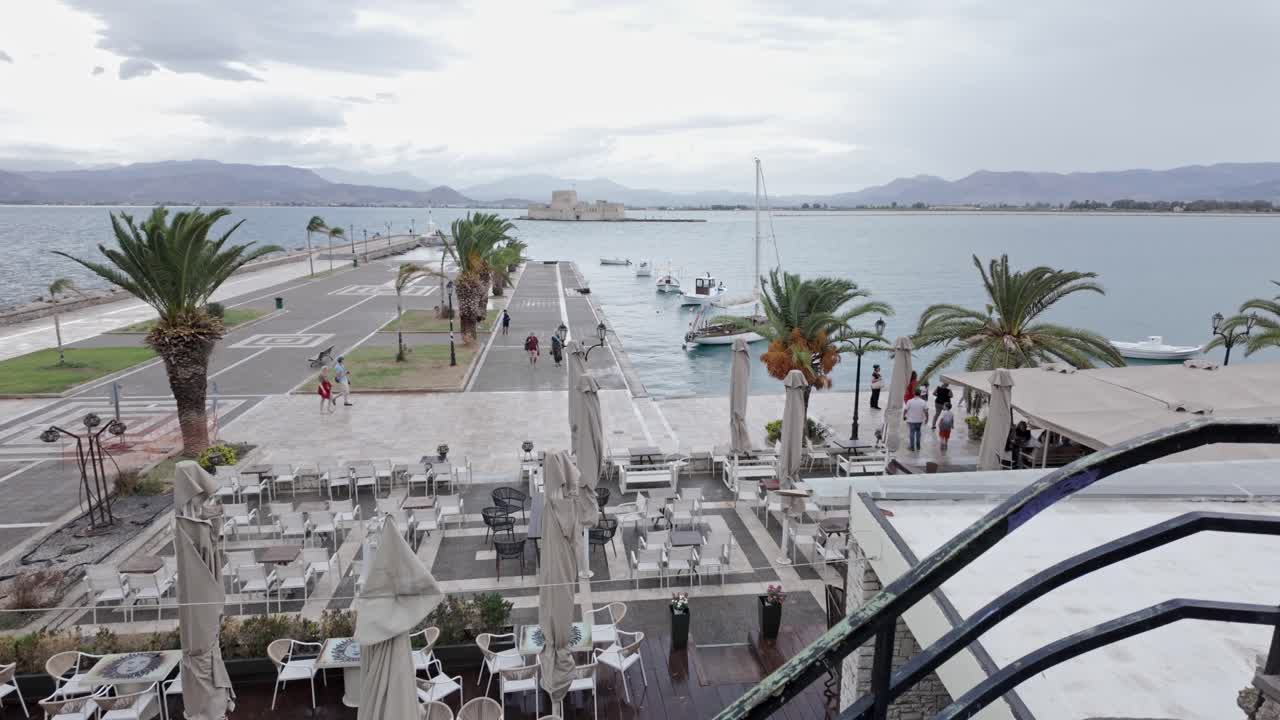 Elevated views over Greek harbour restaurant outdoor dining area Bouritz bay rainy day