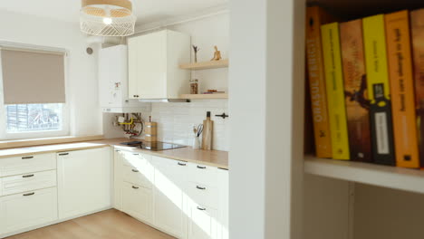 panning left revealing white modern wooden bright renovated kitchen