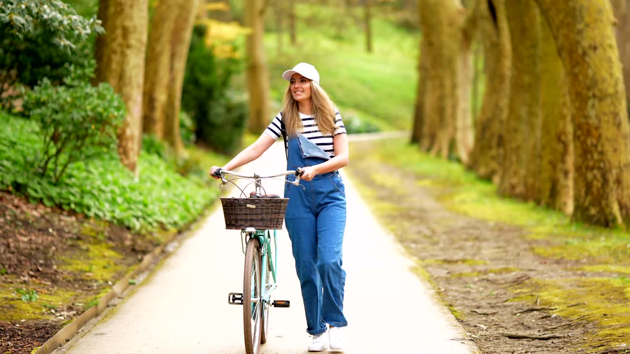 Woman with bicycle in park