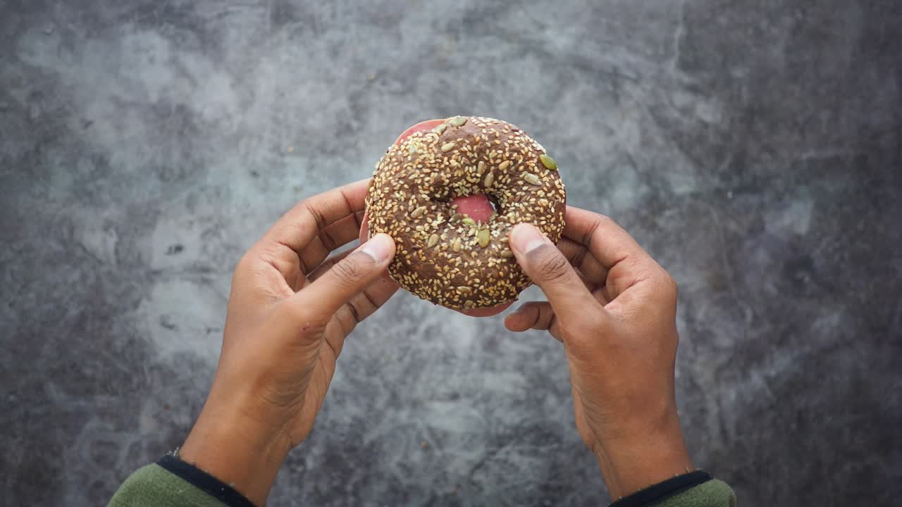 Close-up of a donut held by hands