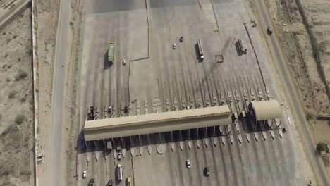 aerial view of a motorway toll plaza of the city, heavy vehicles and others entering and crossing