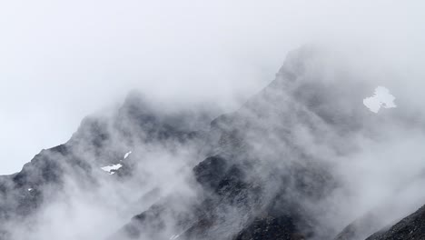 Cloud-swirling-around-mountains,-Sarek,-Sweden