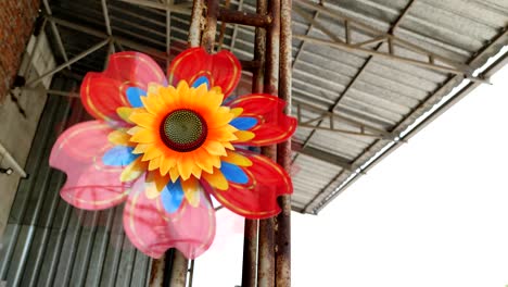 toy windmill in the shape of a sunflower. concept alternative energy.