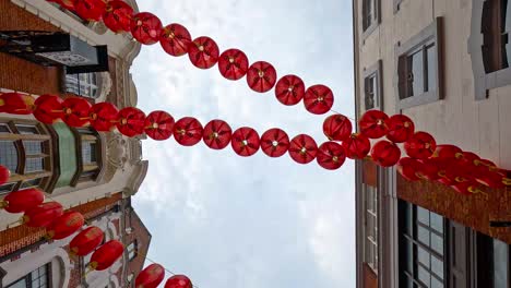 red lanterns strung between buildings in chinatown