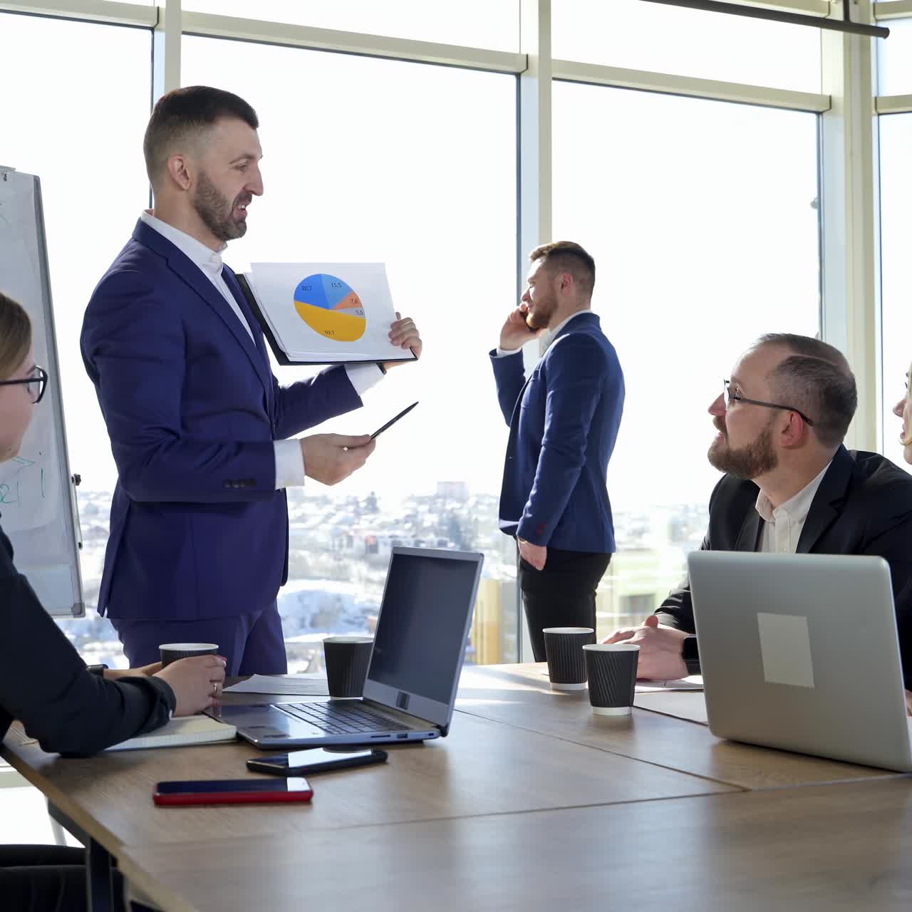 Group of business partners have meeting in modern office. People in suits talking about new project