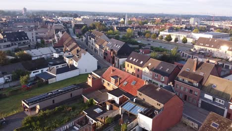 aerial view of small belgian town, buildings and empty streets around sunrise