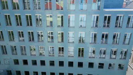 aerial descending view from a modern building with solar panels at rooftop and mirrored windows.lisbon,portugal