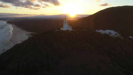 rotating drone shot of sunrise at smoky cape lighthouse near south west rocks, kempsey shire, new south wales, australia