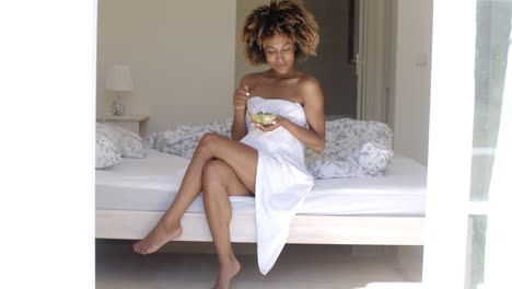 Young-Woman-On-Bed-Eating-Vegetable-Salad