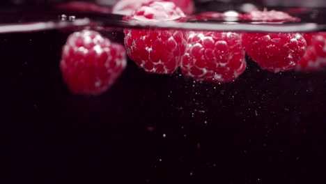 frambuesa fresca en un tazón de vidrio con agua