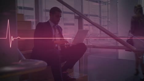 Animation-of-glowing-pink-heart-rate-monitor,-over-businessman-sitting-on-steps-using-laptop