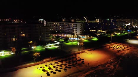 aerial shot of nightlife view of island mallorca beside the beach, spain