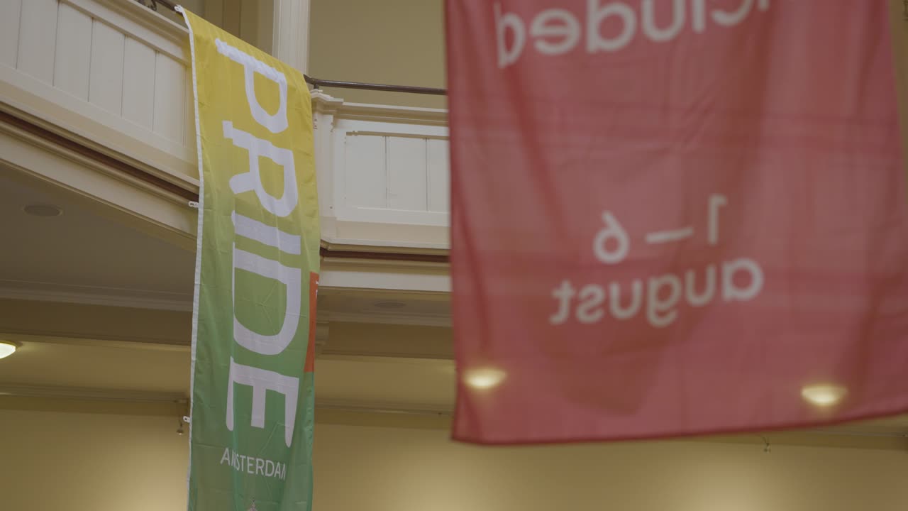 Pride Amsterdam banner hanging inside a classic European interior. Symbol of inclusion and LGBTQ+ visibility within traditional spaces.