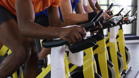 working out on exercise bikes at a gym