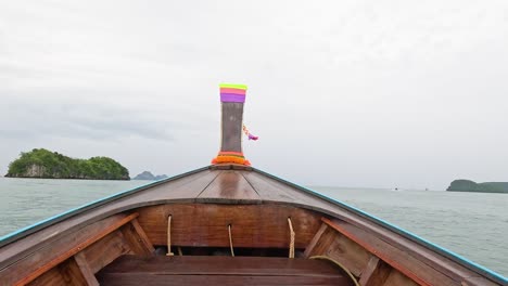 boat travels through ocean towards distant islands