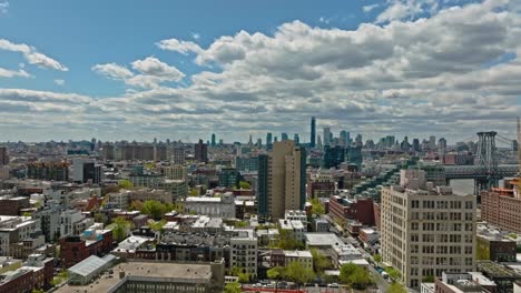 Vuelo-Aéreo-Hacia-Adelante-Sobre-El-Distrito-Noble-De-La-Ciudad-De-Nueva-York-Con-El-Puente-Williamsburg-Durante-El-Día-Soleado:-Hermoso-Paisaje-Urbano-Con-El-Horizonte-Como-Telón-De-Fondo