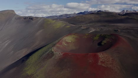 Stunning-View-Of-Raudaskal-Crater-In-Southern-Iceland-With-Red-Volcanic-Soil---panning-drone-shot