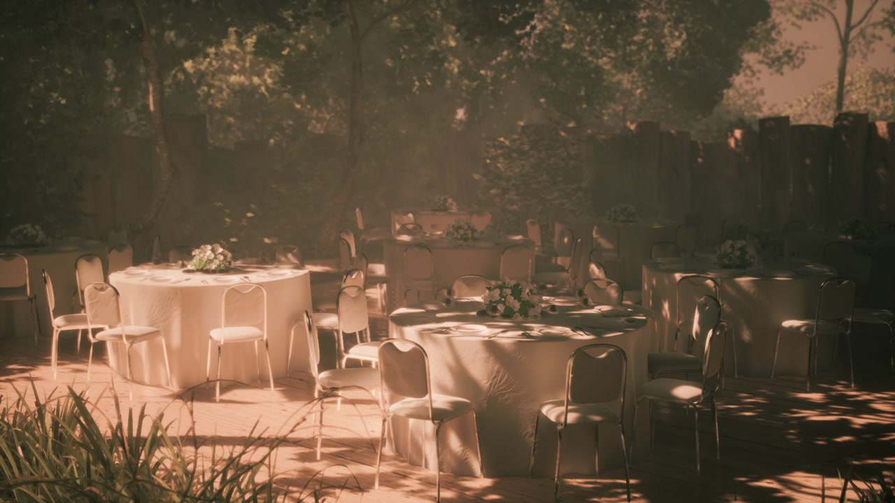 Outdoor dining setup with round tables and floral arrangements in daylight