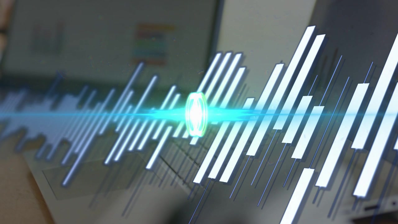 Man typing on laptop keys, audio waveform sweeping over hands, peaking then settling