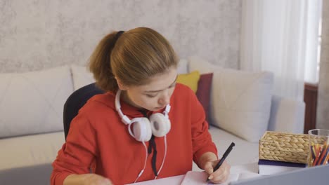 college student girl happily studying at home.