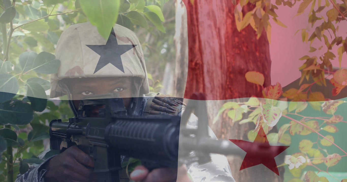 Male soldier shifting forward at woods edge, aiming rifle under defense flag overlay while scanning