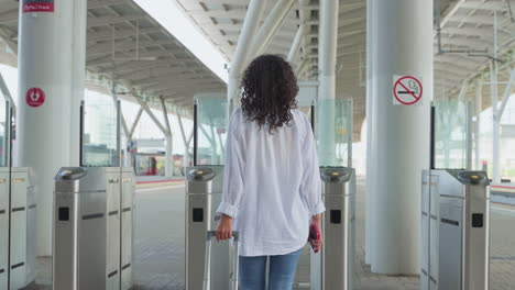 woman walking through train station gate