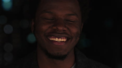 portrait-handsome-african-american-man-on-rooftop-at-night-drinking-alcohol-smiling-happy-enjoying-urban-nightlife-with-bokeh-city-lights-in-background