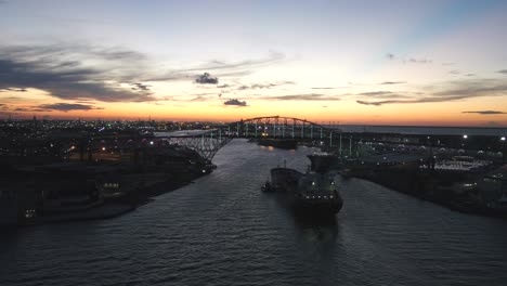 beautiful sunset backdrop of corpus christi bridge and barge boat