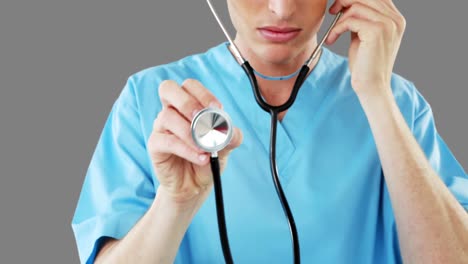 Close-up-of-male-surgeon-checking-with-stethoscope