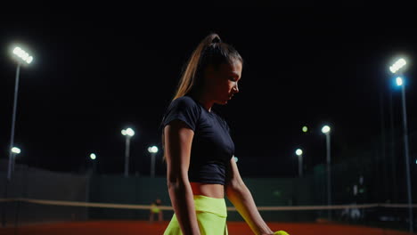 woman playing tennis at night