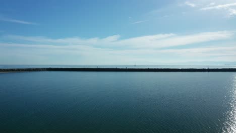 Breakers-along-the-shoreline-and-beach-under-the-blue-skies-and-soft-clouds