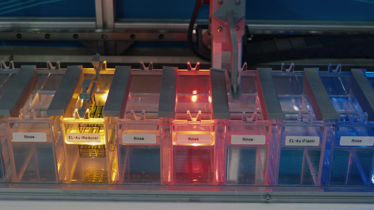 Automated Laboratory Equipment Processing Samples in Colored Chemical Baths