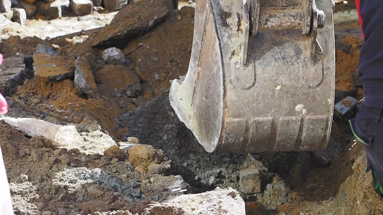 Excavator Removing Pavement and Dirt