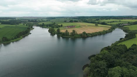 A-mesmerizing-view-from-above-the-Kettering-Reservoir:-green-fields-are-neighbouring-with-water-and-are-stretched-to-the-horizon