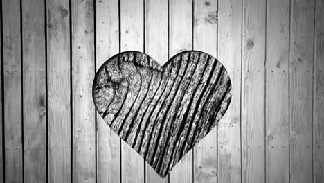 Animation-of-heart-shape-cut-in-wood,-with-moving-wood-grain-pattern,-black-and-white