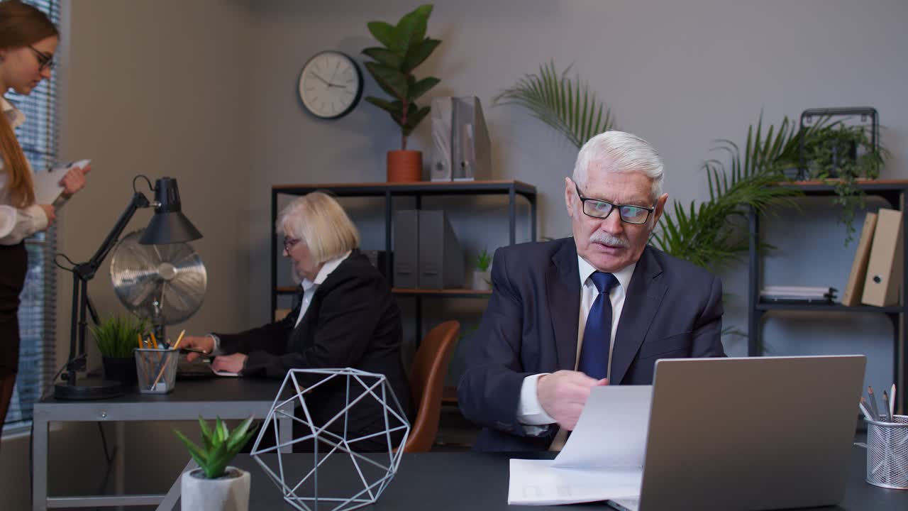 Displeased mature businessman accountant throwing documents after analyzing financial papers, crisis