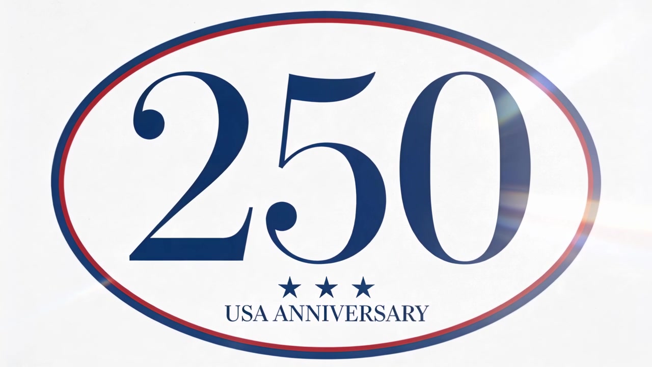 Visualizzazione di un ovale con "250 USA ANNIVERSARY" su sfondo bianco, con un bagliore dell'obiettivo che si sposta, evidenziando lo zero a destra.