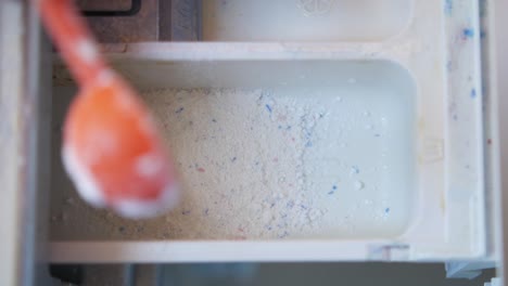 adding detergent to a washing machine