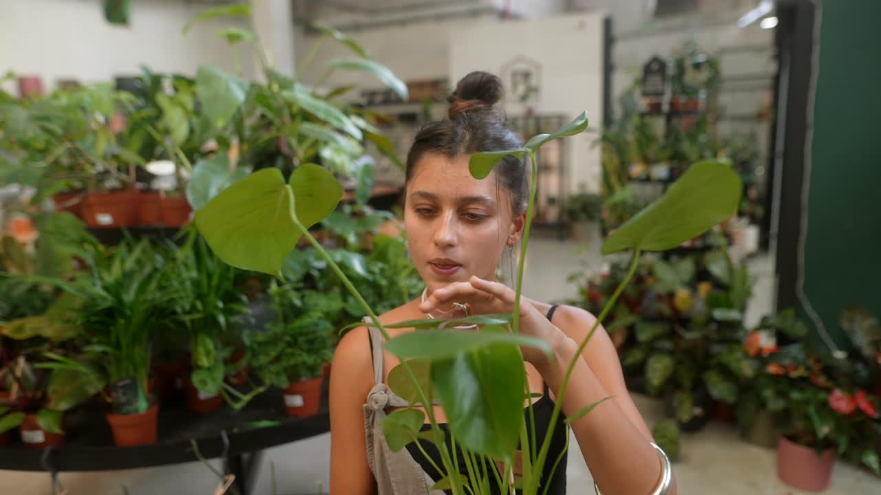 A woman tending to indoor plants