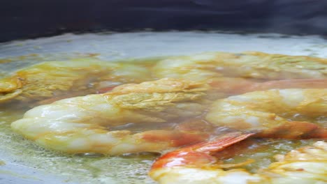 cooking delicious shrimp curry in a wok