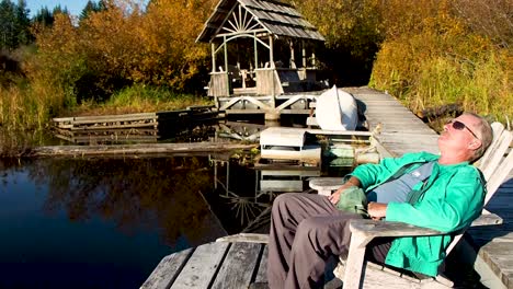 Man-relaxing-on-dock