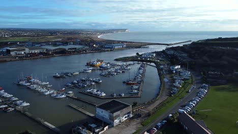 wide angle aerial shot coastal town in england with harbour and marina