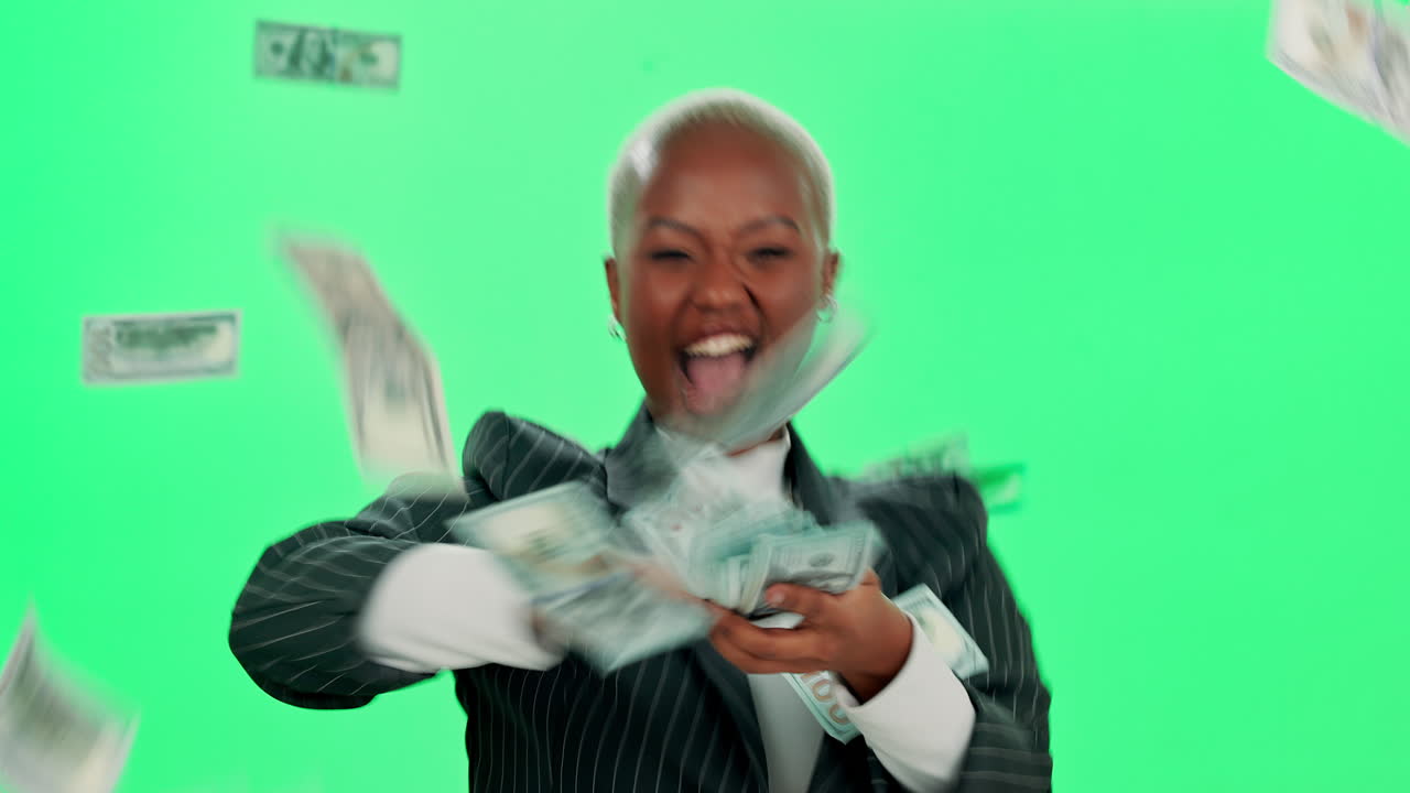 Excited woman with money on green screen